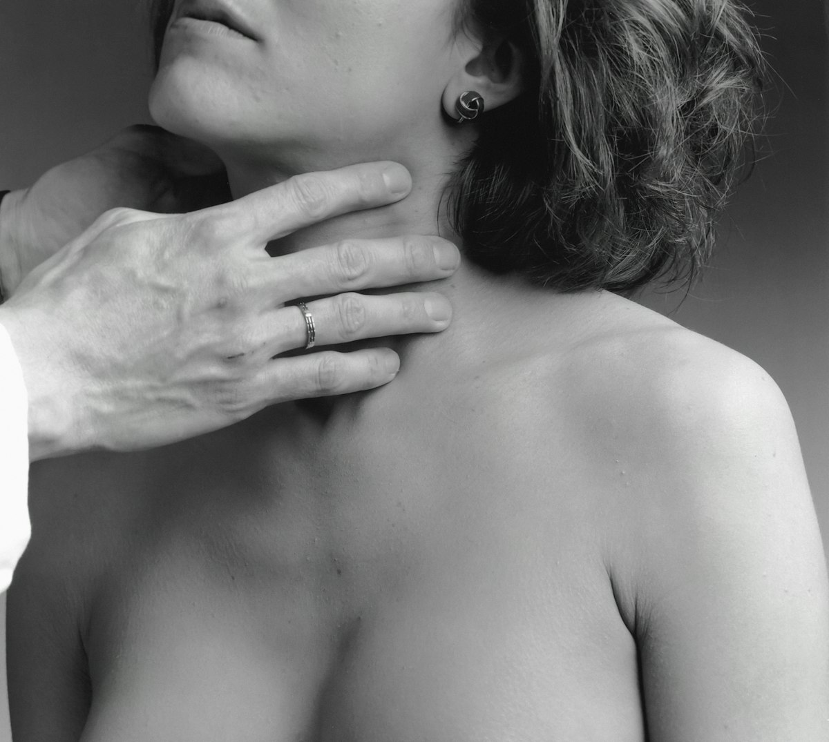a woman has her hand on the shoulder of a man